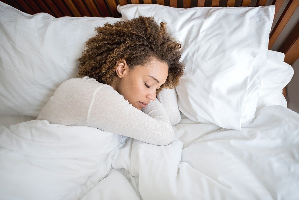 lady sleeping having comfortable bed sheets